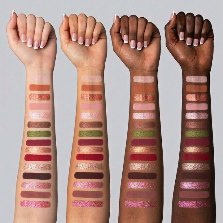 Four arms with different skin tones displaying a variety of eyeshadow swatches.